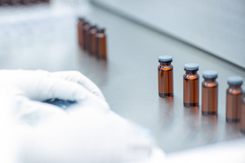 Compounding pharmacy lab with amber vials, representing peptide formulation and review