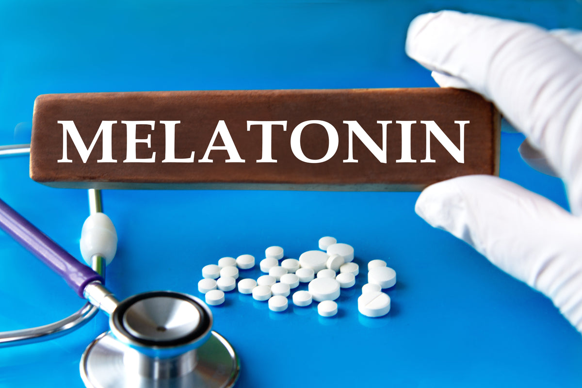 Pharmacist hand with melatonin pills and stethoscope.
