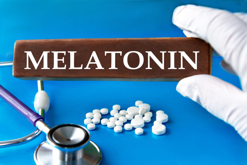 Pharmacist hand with melatonin pills and stethoscope.