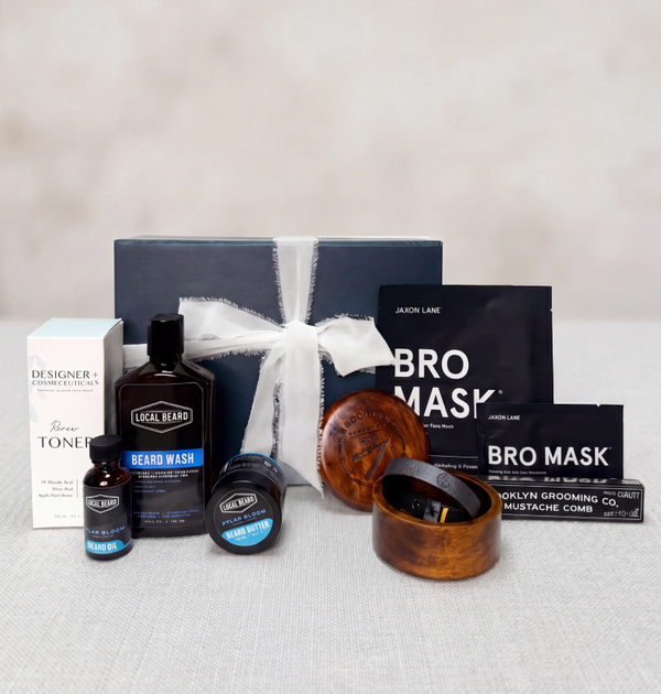 Father's Day collection of grooming products including bottles, masks, and a box on a neutral background