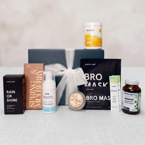 Father's Day collection of skincare and wellness products on a light gray surface with a neutral background.
